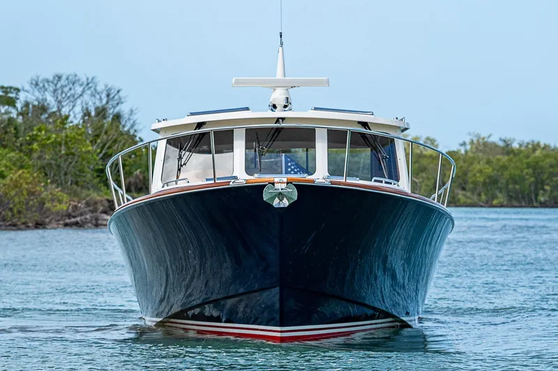 Slide: The Image of Front view of a 2021 Hinckley Talaria 43 yacht on calm water. - 9