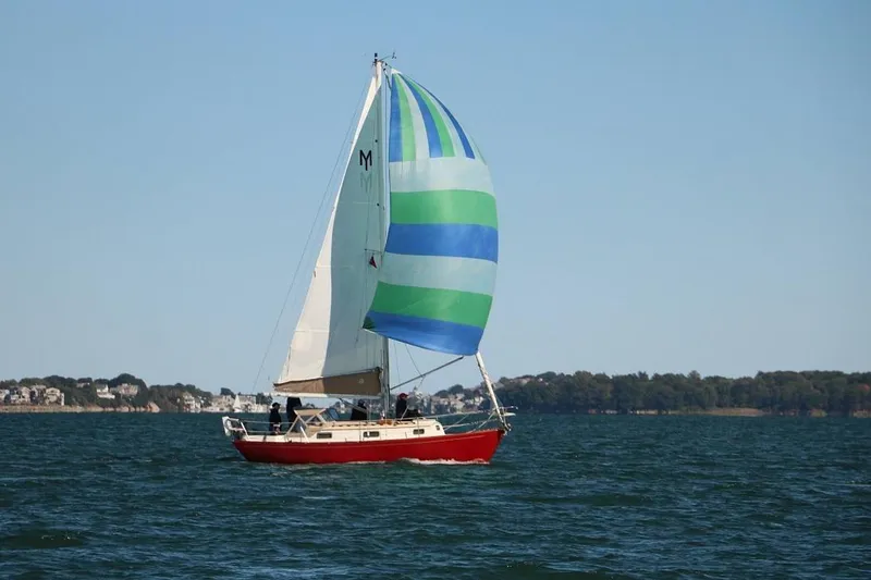 The Image of Red sailboat with colorful spinnaker sailing on a sunny day, Morris Linda 1987 model. - 0