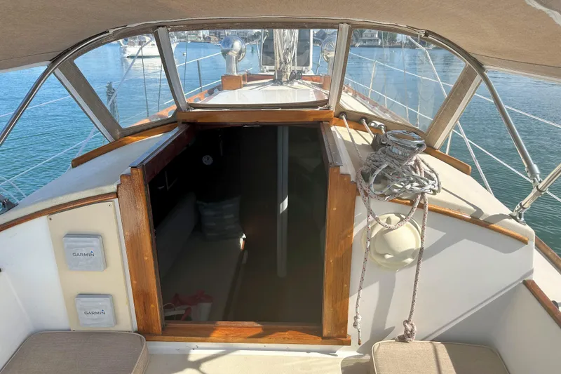 Slide: The Image of Cockpit view of a 1987 Morris Linda sailboat, featuring Garmin equipment and nautical ropes. - 15