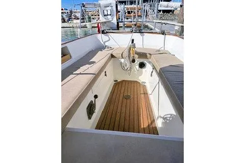 Slide: The Image of 1987 Morris Linda boat interior with wooden deck and cushioned seating. - 17