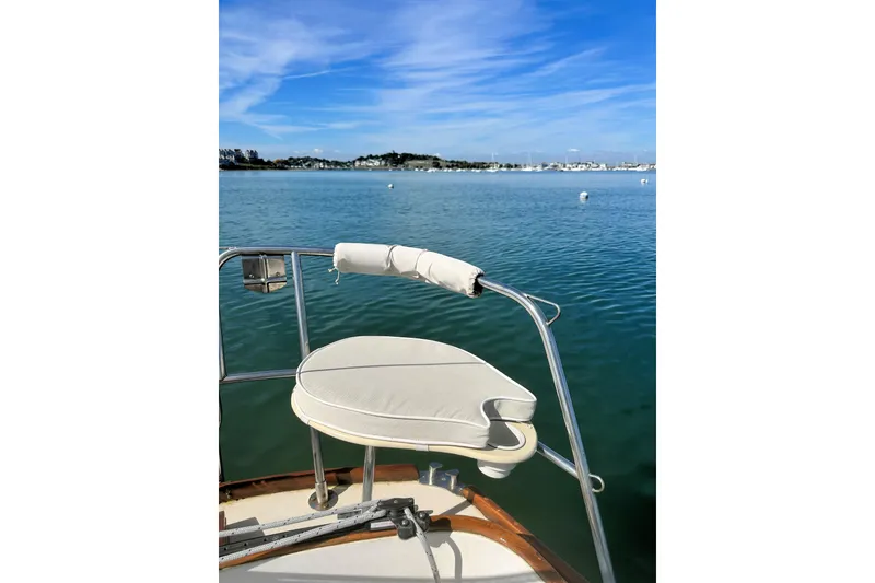 Slide: The Image of Boat deck with cushioned seat overlooking calm blue water, Morris Linda 1987. - 19