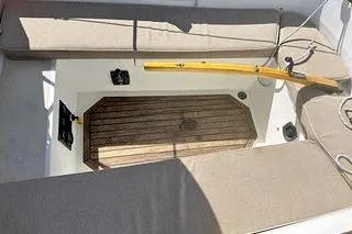 Slide: The Image of 1987 Morris Linda boat interior with wooden deck and cushioned seating. - 23