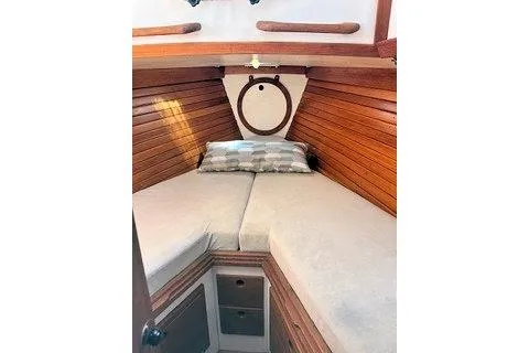 Slide: The Image of 1987 Morris Linda boat cabin with wooden interior and cozy bedding. - 24