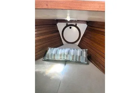 Slide: The Image of Cozy cabin interior of 1987 Morris Linda boat with wooden paneling and striped pillow. - 25