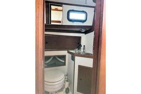 Slide: The Image of 1987 Morris Linda boat bathroom with wooden cabinetry and compact design. - 26