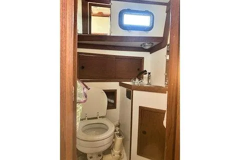 Slide: The Image of 1987 Morris Linda boat bathroom with wooden cabinetry and compact design. - 27
