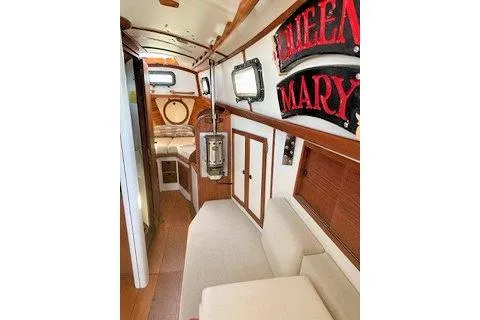 Slide: The Image of Interior of a 1987 Morris Linda boat with cozy seating and nautical decor. - 28