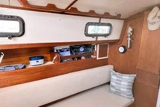 Slide: The Image of 1987 Morris Linda boat interior with wooden finish, cushioned seating, and nautical decor. - 30