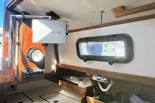 Slide: The Image of 1987 Morris Linda boat interior with Garmin navigation, porthole, and wooden accents. - 33