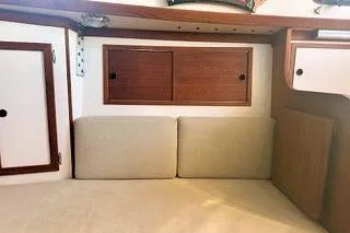 Slide: The Image of Interior of a 1987 Morris Linda boat with wooden cabinets and beige cushions. - 34