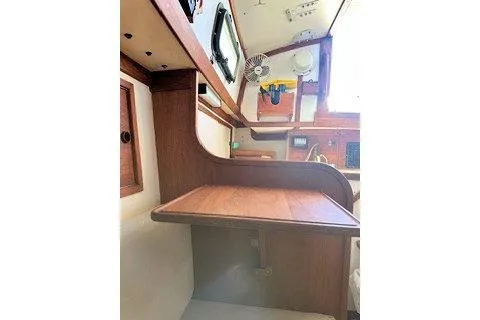 Slide: The Image of 1987 Morris Linda yacht interior with wooden desk and window view. - 36