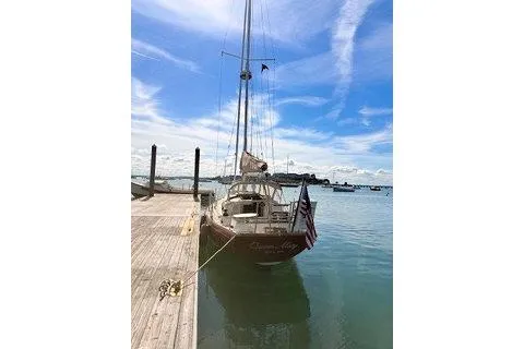 Slide: The Image of Sailboat docked at marina, Morris Linda 1987, under a clear blue sky. - 6