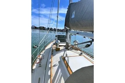 Slide: The Image of Sailboat deck view, Morris Linda 1987, on calm waters under a clear blue sky. - 7