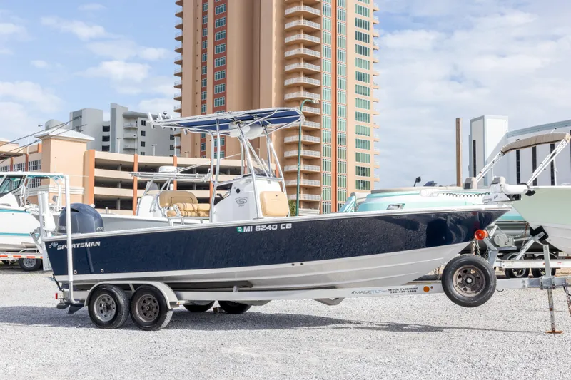 The Image of 2021 Sportsman Masters 227 Bay Boat on trailer, urban background, clear sky. - 0