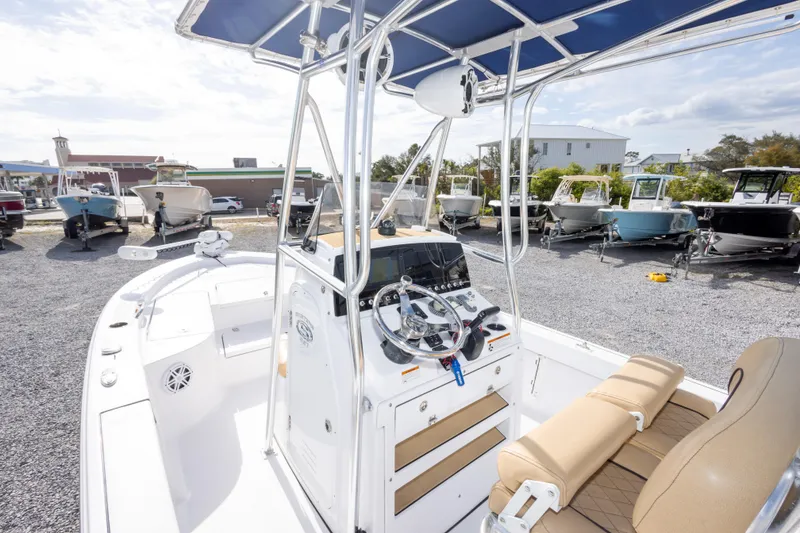 Slide: The Image of 2021 Sportsman Masters 227 Bay Boat with Minn Kota Ulterra motor, parked outdoors. - 11