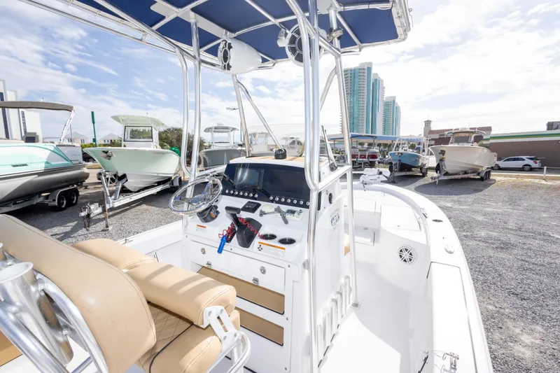 Slide: The Image of 2021 Sportsman Masters 227 Bay Boat with modern console and seating, displayed outdoors. - 12