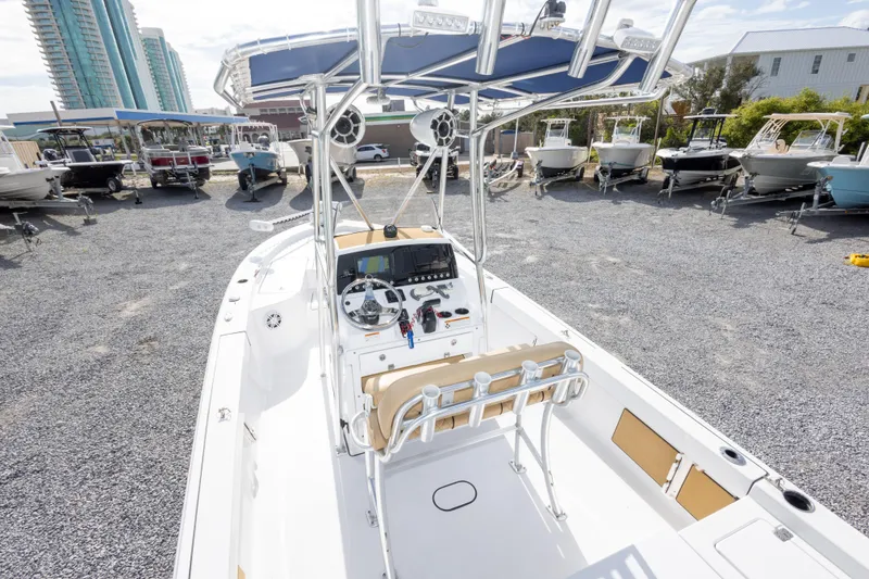 Slide: The Image of 2021 Sportsman Masters 227 Bay Boat with console and seating, displayed outdoors. - 13