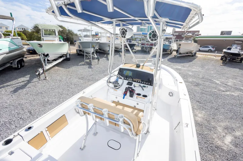 Slide: The Image of 2021 Sportsman Masters 227 Bay Boat in a marina with other boats. - 14