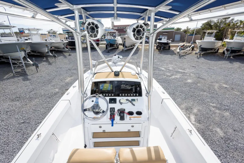 Slide: The Image of 2021 Sportsman Masters 227 Bay Boat with T-top and console, parked in a boatyard. - 15