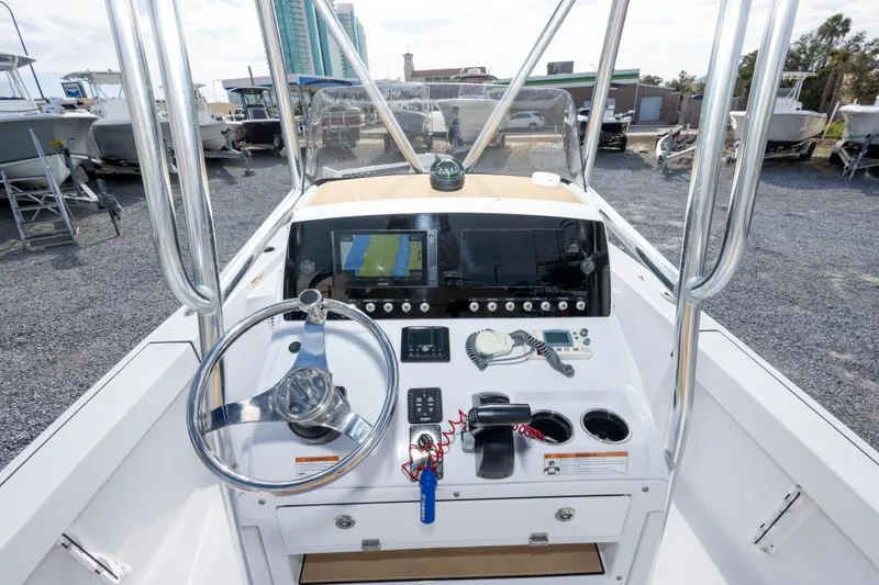 Slide: The Image of 2021 Sportsman Masters 227 Bay Boat with tan seating and powerful outboard motor. - 21