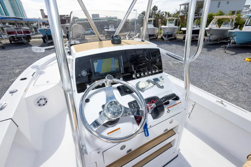 Slide: The Image of 2021 Sportsman Masters 227 Bay Boat dashboard with steering wheel and navigation controls. - 22