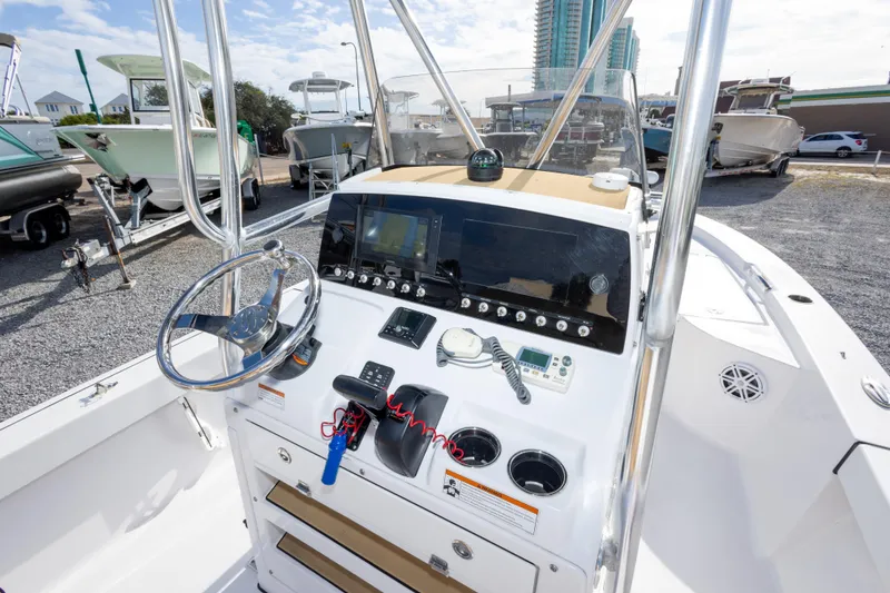 Slide: The Image of 2021 Sportsman Masters 227 Bay Boat dashboard with steering wheel and navigation display. - 23