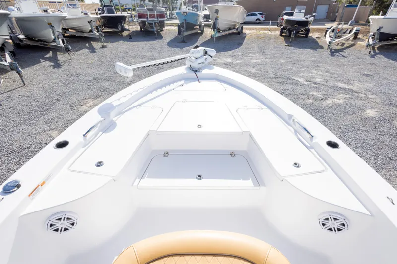 Slide: The Image of 2021 Sportsman Masters 227 Bay Boat with tan seating, displayed in a boatyard. - 26