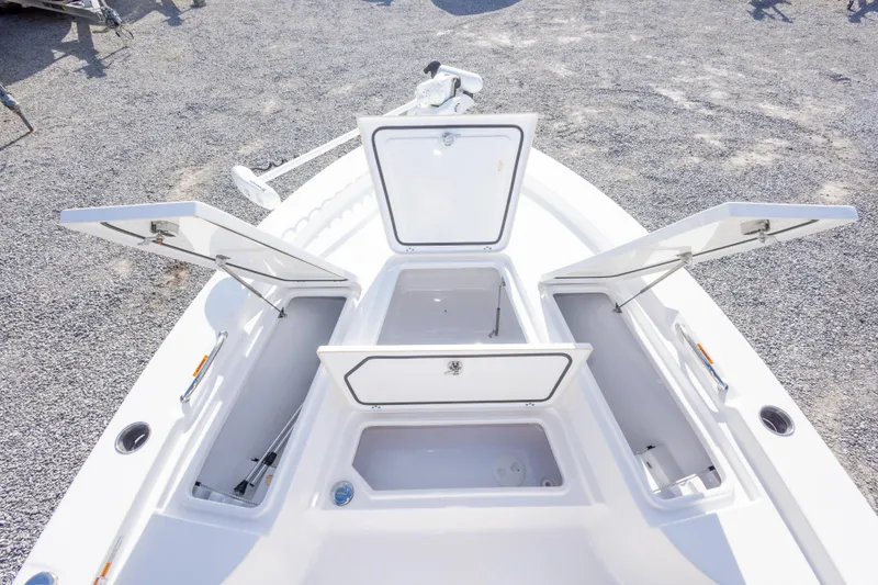 Slide: The Image of 2021 Sportsman Masters 227 Bay Boat deck view, showcasing storage compartments and seating. - 27
