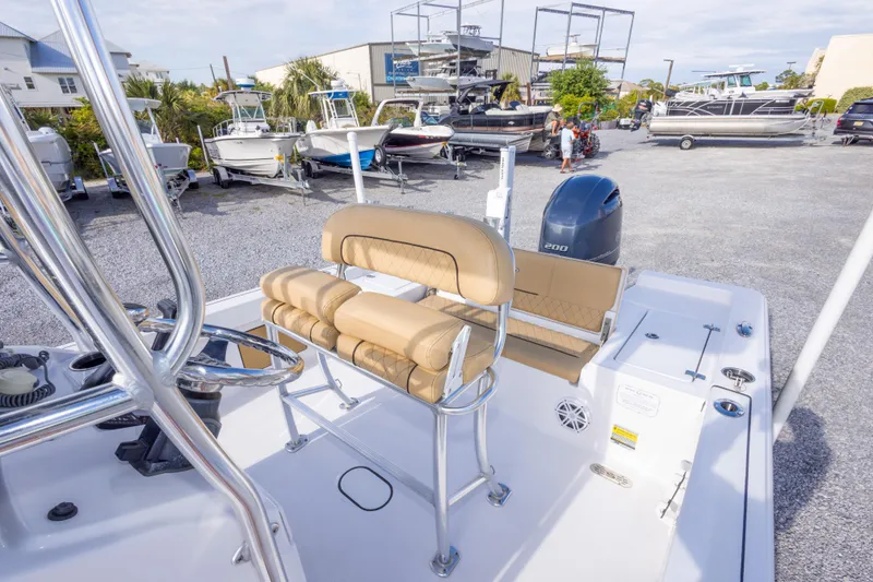 Slide: The Image of 2021 Sportsman Masters 227 Bay Boat with T-top in a marina setting. - 30