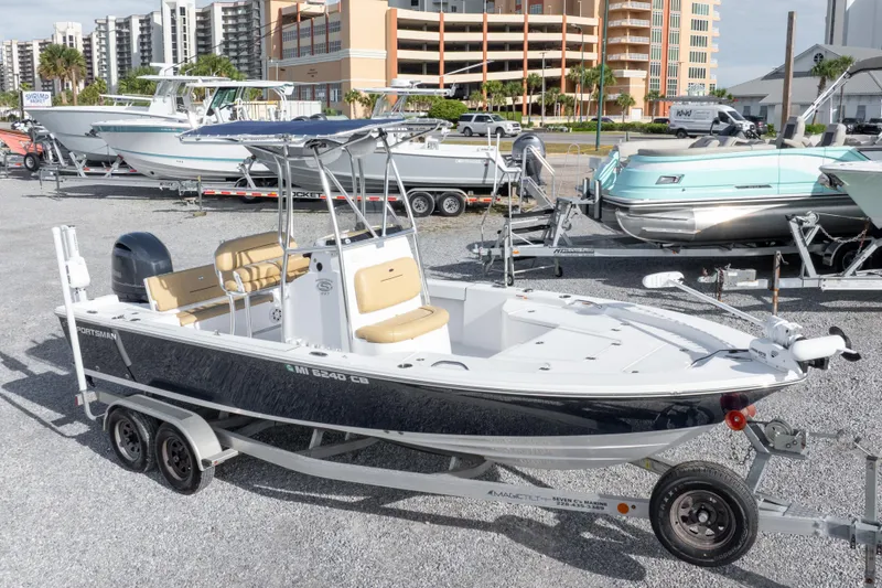 Slide: The Image of 2021 Sportsman Masters 227 Bay Boat with beige seating, parked in a marina. - 33
