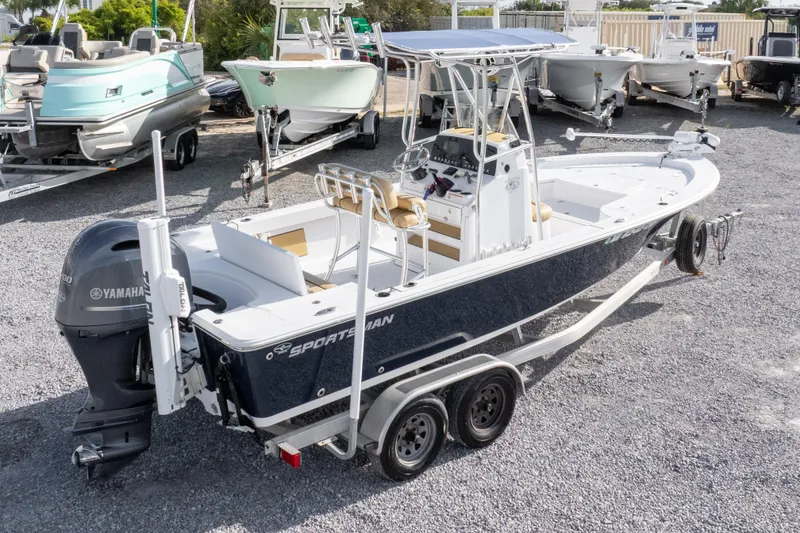 Slide: The Image of 2021 Sportsman Masters 227 Bay Boat on trailer, parked in marina with other boats. - 35