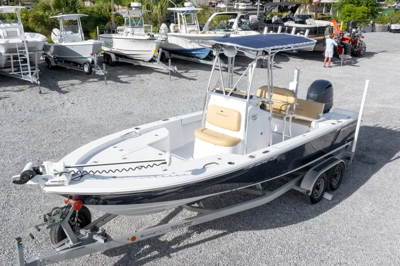 Slide: The Image of 2021 Sportsman Masters 227 Bay Boat on trailer, surrounded by other boats in a lot. - 39