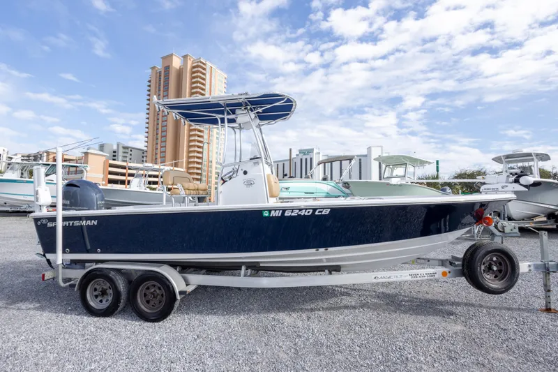 Slide: The Image of 2021 Sportsman Masters 227 Bay Boat with Yamaha engine on trailer, urban backdrop. - 4