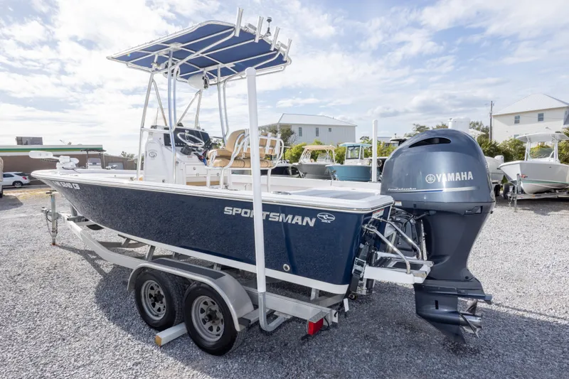 Slide: The Image of 2021 Sportsman Masters 227 Bay Boat with powerful outboard motor in a marina setting. - 7