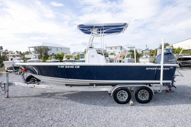 Slide: The Image of 2021 Sportsman Masters 227 Bay Boat with Yamaha engine on trailer, parked outdoors. - 8