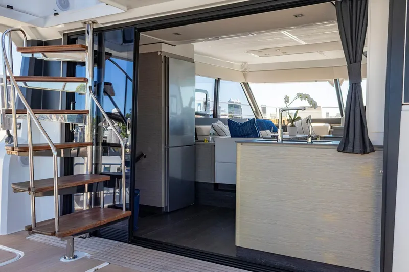 Slide: The Image of 2024 Fountaine Pajot MY5 yacht interior with modern kitchen and spiral staircase. - 19