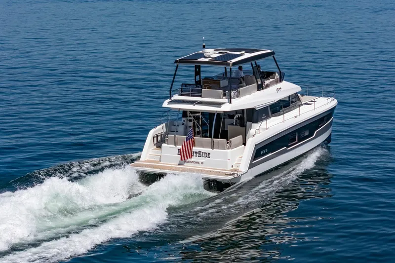 Slide: The Image of 2024 Fountaine Pajot MY5 yacht cruising on open water, rear view. - 2