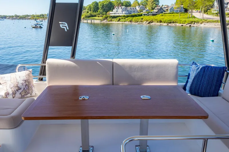 Slide: The Image of Outdoor seating area on 2024 Fountaine Pajot MY5 yacht, overlooking serene waterfront. - 52