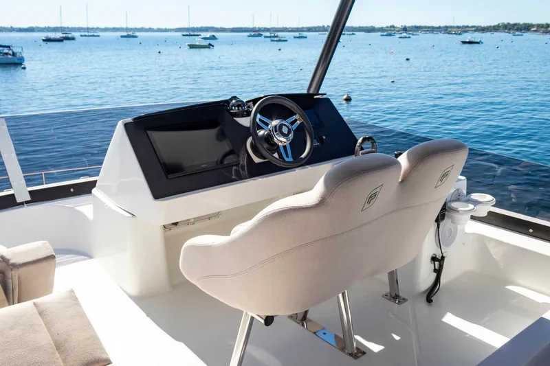 Slide: The Image of 2024 Fountaine Pajot MY5 yacht helm with dual seats overlooking serene waters. - 7