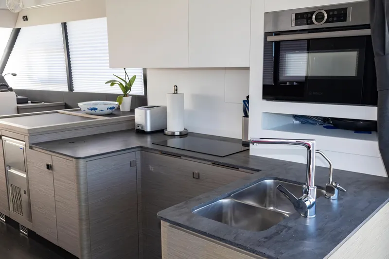 Slide: The Image of Modern kitchen interior of 2024 Fountaine Pajot MY5 yacht with sleek appliances and fixtures. - 43