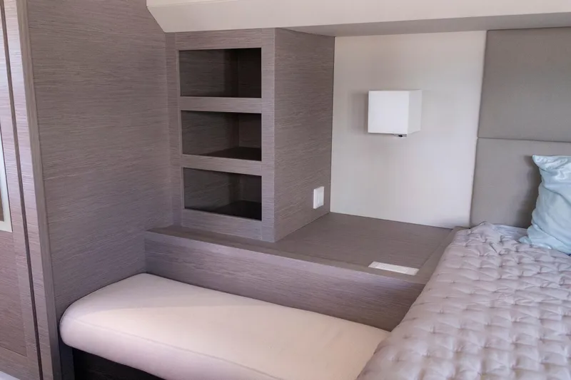Slide: The Image of Interior of 2024 Fountaine Pajot MY5 yacht with modern shelving and cozy bedding. - 48