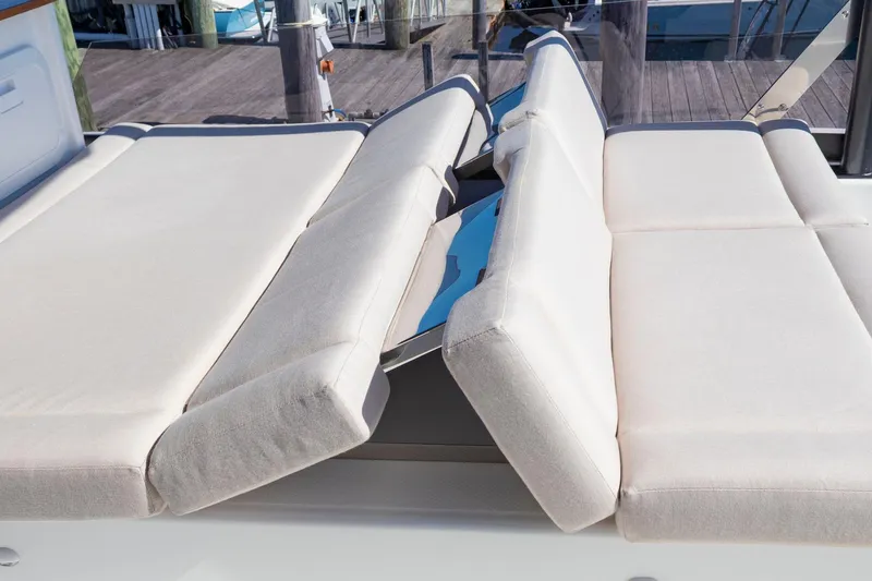 Slide: The Image of Adjustable sunbed on 2024 Fountaine Pajot MY5 yacht, featuring comfortable beige cushions. - 53