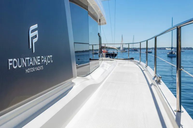 Slide: The Image of 2024 Fountaine Pajot MY5 yacht on calm water, showcasing sleek design and branding. - 54