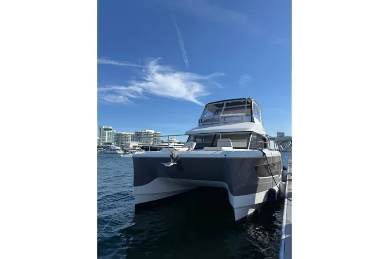 Slide: The Image of 2024 Fountaine Pajot MY5 yacht docked in a marina under a clear blue sky. - 10
