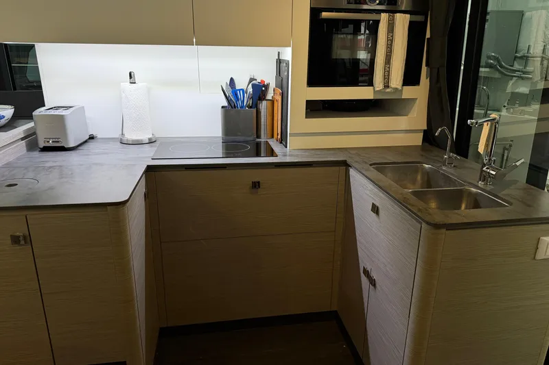 Slide: The Image of Modern kitchen in 2024 Fountaine Pajot MY5 yacht with sleek countertops and appliances. - 13