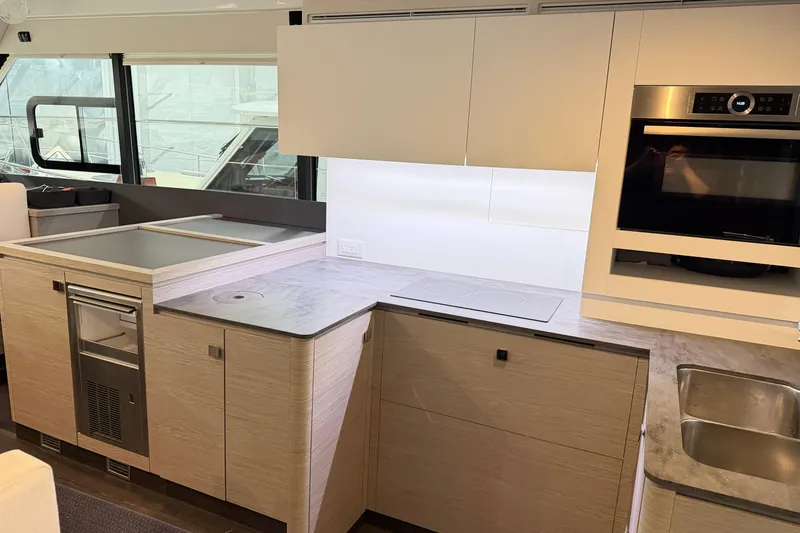 Slide: The Image of Modern kitchen interior of 2024 Fountaine Pajot MY5 yacht with sleek appliances and cabinetry. - 14