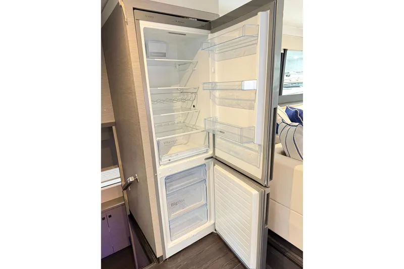 Slide: The Image of Modern refrigerator inside 2024 Fountaine Pajot MY5 yacht, featuring spacious interior and sleek design. - 21