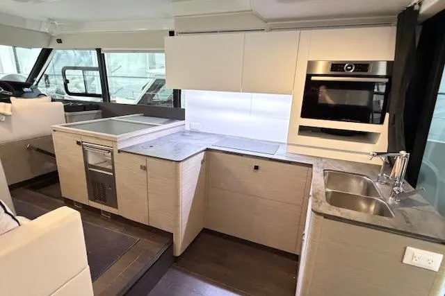 Slide: The Image of Modern kitchen interior of 2024 Fountaine Pajot MY5 yacht with sleek cabinetry and appliances. - 23