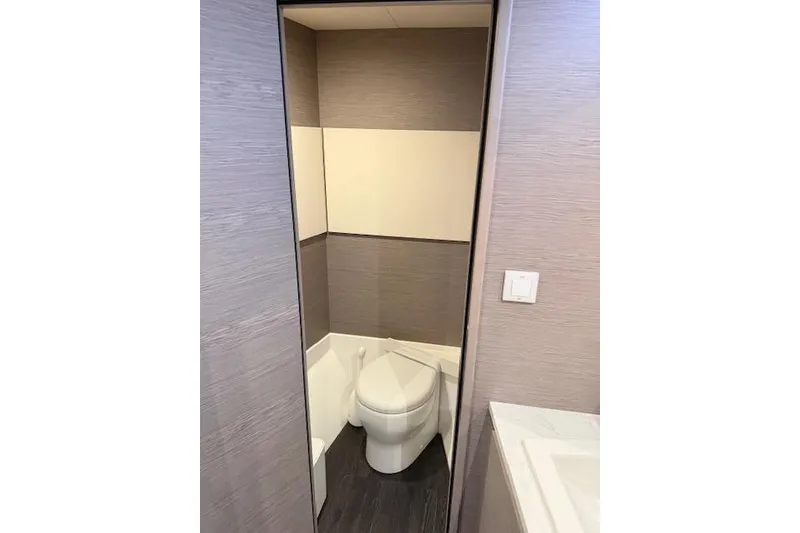 Slide: The Image of 2024 Fountaine Pajot MY5 yacht bathroom with modern design and compact toilet. - 27