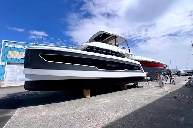 Slide: The Image of 2024 Fountaine Pajot MY5 yacht on display at a marina under a clear blue sky. - 3